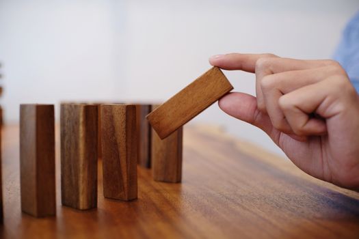 Planning risk and strategy in businessman gambling placing wooden block.Business concept for growth success process.