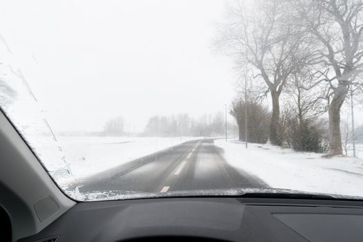 View from a car to road with snow in Winter