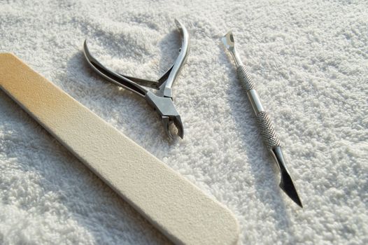 Tools of a manicure set on white background, concept of care of nails and cuticles.