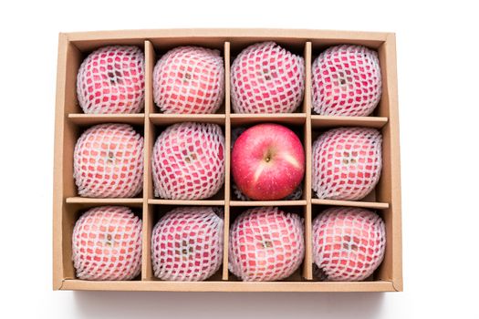 red apples with shockproof foam net wrap in paper box isolated on white background