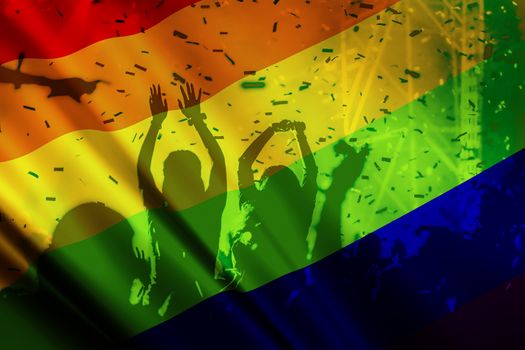 silhouette of a parade of gays and lesbians with a rainbow flag - symbol of love and tolerance