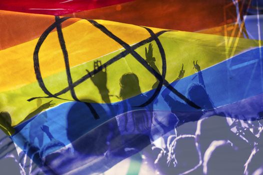 silhouette of a parade of gays and lesbians with a rainbow flag - symbol of love and tolerance