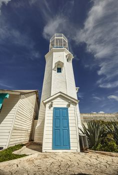 White and blue lighthouse: the lighthouse of Isla Mujeres in Mexico.