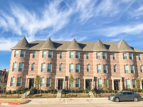New townhome apartment complex with cars park on street near Dallas, Texas, USA