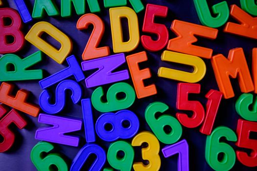 Colorful magnetic numbers and letters grouped on the fridge
