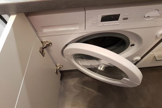 Opened door of a washing machine to prepare the wash.