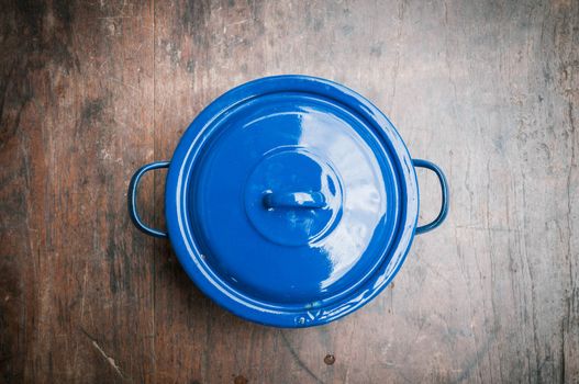blue of cooking pot on wooden background