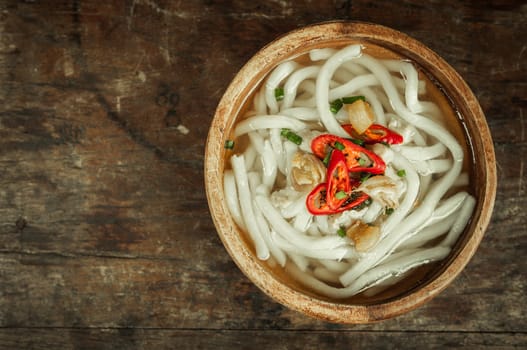 udon noodle in wood bowl on wooden floor background