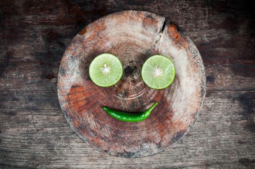 Green Lemon cut on wood block