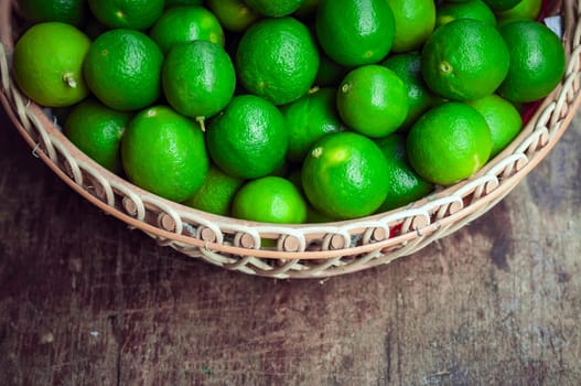 Green lemon in rattan basket