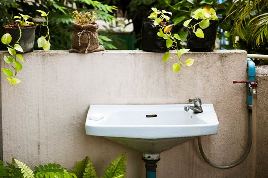 vintage of washbasin and grunge wall in the garden