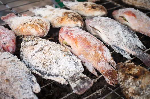 Closeup of roasting fish with salt