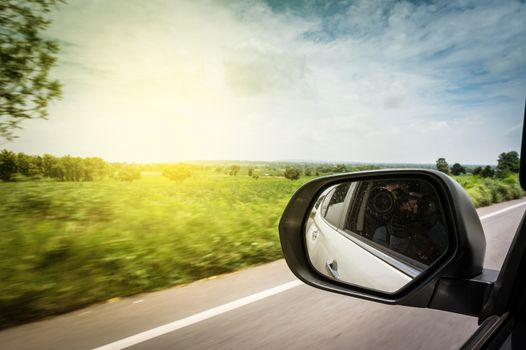 car mirror and photographer take a photo of inside road
