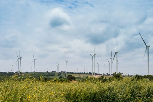 Wind Turbine Generator stands among farm landscape