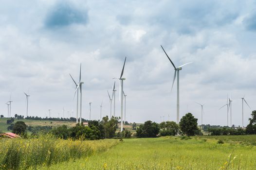 Wind Turbine Generator stands among farm landscape