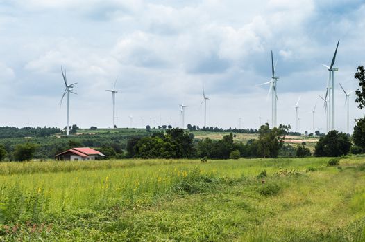 Wind Turbine Generator stands among farm landscape