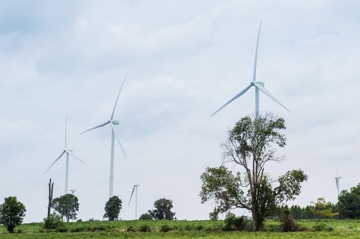 Wind Turbine Generator stands among farm landscape