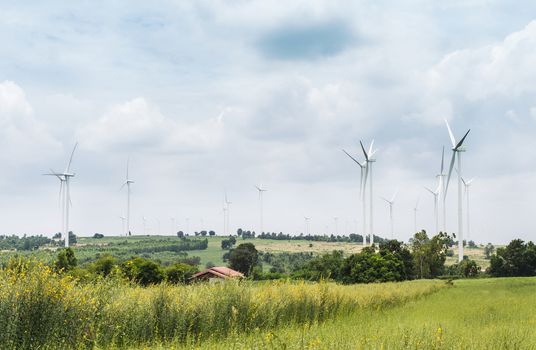 Wind Turbine Generator stands among farm landscape
