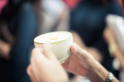 closeup of hand holding a coffee cup