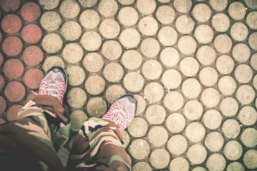 Closeup of shoes and brick floor