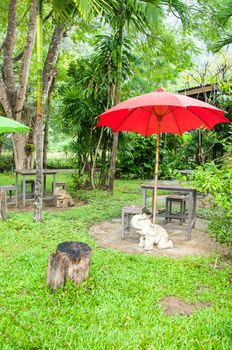 Table and red umbrella in the garden