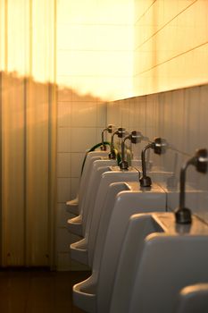 Closeup of white urinals row in public toilets