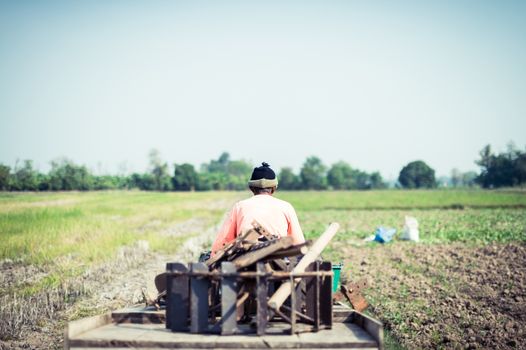 farmer driving tractor in a farm, career life of Thailand