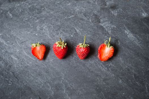 Strawberry fruit on black stone background