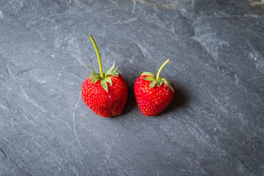 Strawberry fruit on black stone background