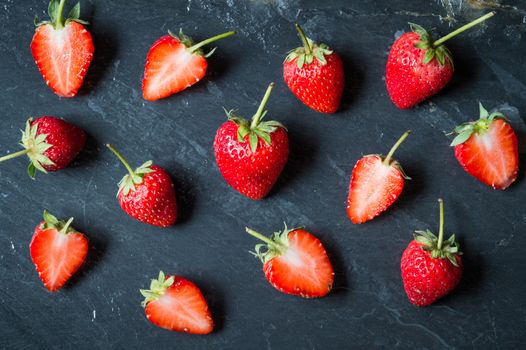 Strawberry fruit on black stone background