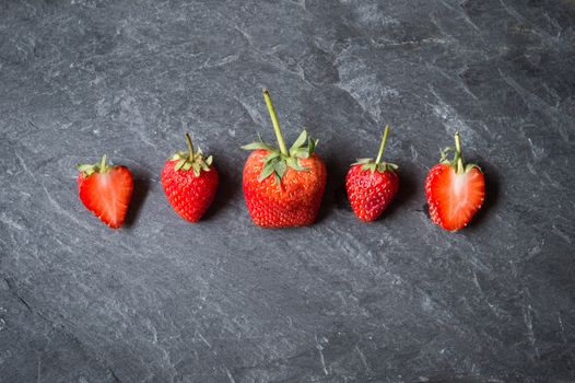 Strawberry fruit on black stone background