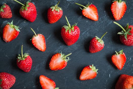 Strawberry fruit on black stone background
