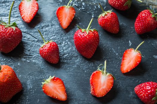 Strawberry fruit on black stone background