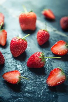 closeup of Strawberry fruit on black stone background
