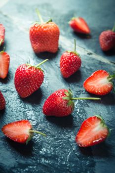 closeup of Strawberry fruit on black stone background