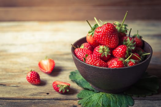 Strawberry fruit in wood cup closeup