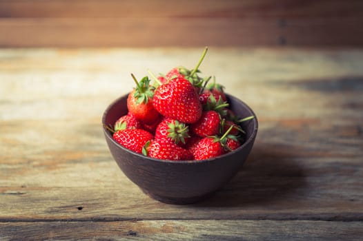 Strawberry fruit in wood cup closeup