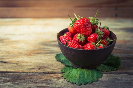 Strawberry fruit in wood cup closeup