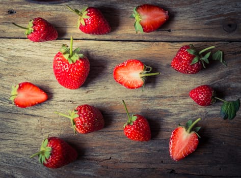 closeup of strawberry fruit on grunge wooden background