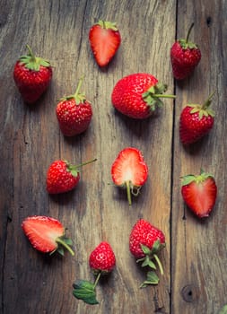 closeup of strawberry fruit on grunge wooden background