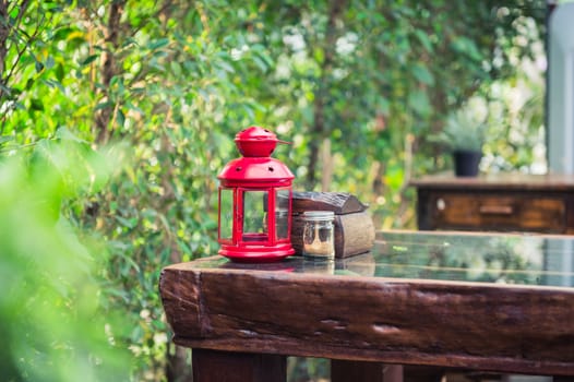 closeup of red lantern on wood table