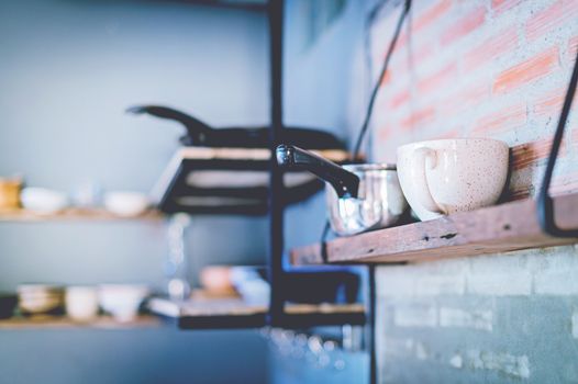 Closeup of kitchen tool equipment on wood shelf, loft interior design conception