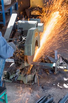 Worker Cutting of Steel in workshop