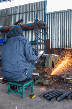 Worker Cutting of Steel in workshop