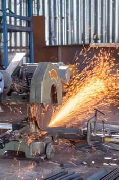 Worker Cutting of Steel in workshop