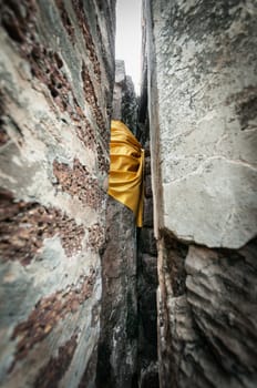 Closeup yellow fabric bind of stone wall, Traditional buddhism style in temple