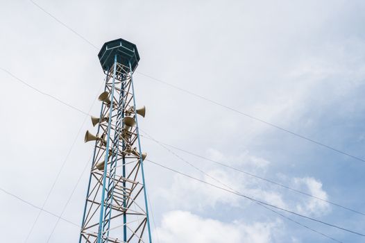 Loudspeaker tower and clouds sky