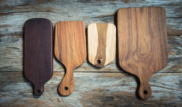 Chopping board on wooden plank background