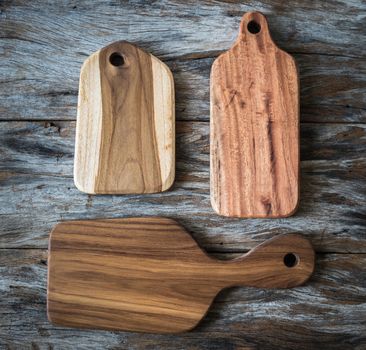 Chopping board on wooden plank background