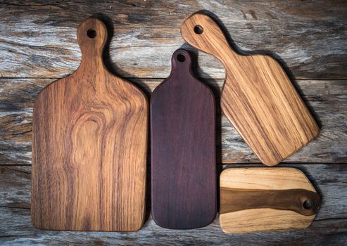 Chopping board on wooden plank background